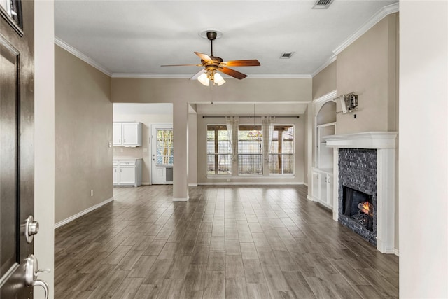 110 Rustling Wind Dr, Montgomery, TX 77356 - unfurnished living room featuring ceiling fan, crown molding, a stone fireplace, and wood finished floors