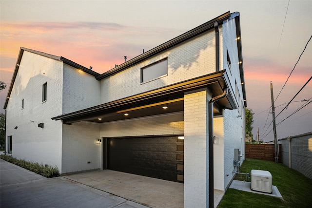 431 W 30th St, Houston, TX 77018 - contemporary house featuring brick siding, an attached garage, and driveway