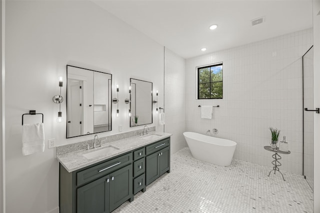 431 W 30th St, Houston, TX 77018 - full bath featuring double vanity, a freestanding tub, and tile walls