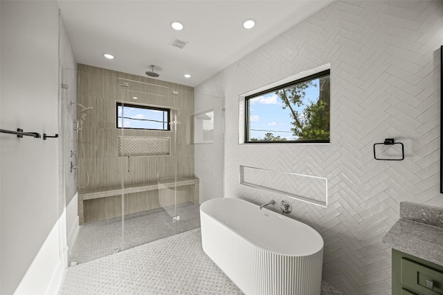 431 W 30th St, Houston, TX 77018 - full bathroom with plenty of natural light, a stall shower, a freestanding bath, vanity, and tile walls