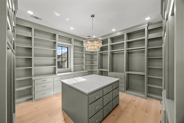 431 W 30th St, Houston, TX 77018 - walk in closet featuring light wood-style flooring and a chandelier