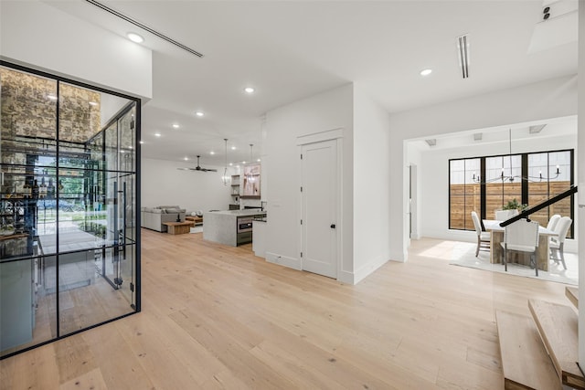 431 W 30th St, Houston, TX 77018 - hallway with light wood finished floors, plenty of natural light, and recessed lighting