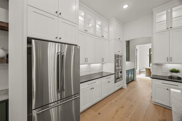 431 W 30th St, Houston, TX 77018 - kitchen with appliances with stainless steel finishes, recessed lighting, white cabinets, backsplash, and light wood-style flooring