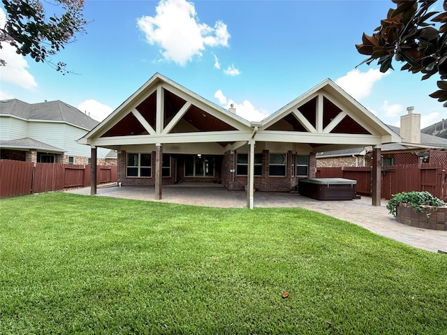 4327 Estes Ridge Ln, Katy, TX 77493 - rear view of property featuring a hot tub, a patio, a fenced backyard, and brick siding