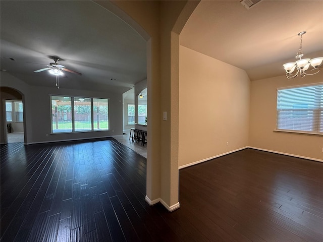 4327 Estes Ridge Ln, Katy, TX 77493 - empty room featuring arched walkways, dark wood-style flooring, a ceiling fan, a chandelier, and vaulted ceiling