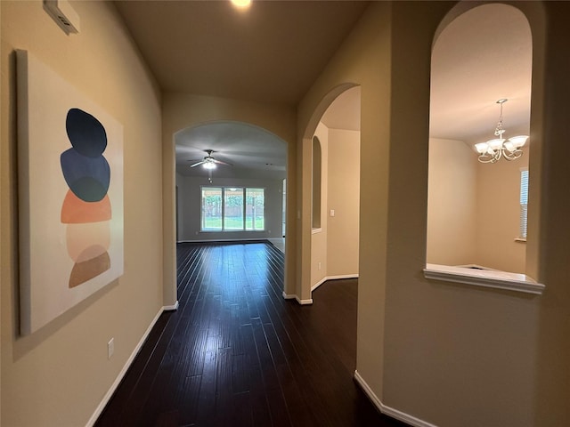 4327 Estes Ridge Ln, Katy, TX 77493 - corridor featuring arched walkways, dark wood-type flooring, and a chandelier