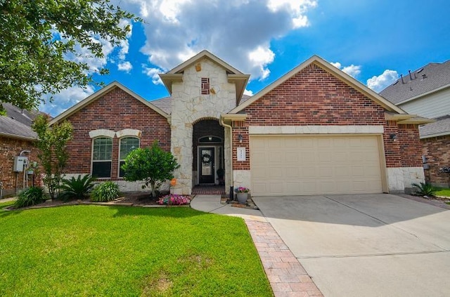 4327 Estes Ridge Ln, Katy, TX 77493 - view of front facade with stone siding, an attached garage, brick siding, a front yard, and driveway