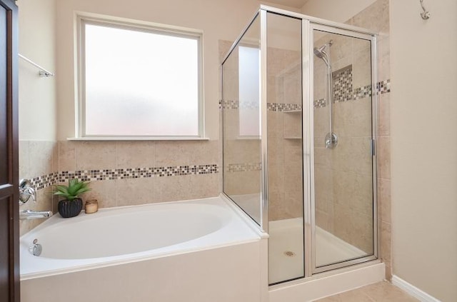 4327 Estes Ridge Ln, Katy, TX 77493 - bathroom with healthy amount of natural light, a garden tub, a shower stall, and tile patterned flooring