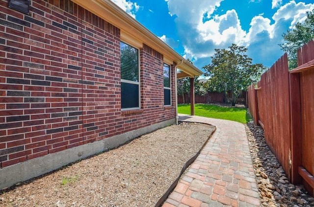 4327 Estes Ridge Ln, Katy, TX 77493 - view of side of home with brick siding, a fenced backyard, and a patio