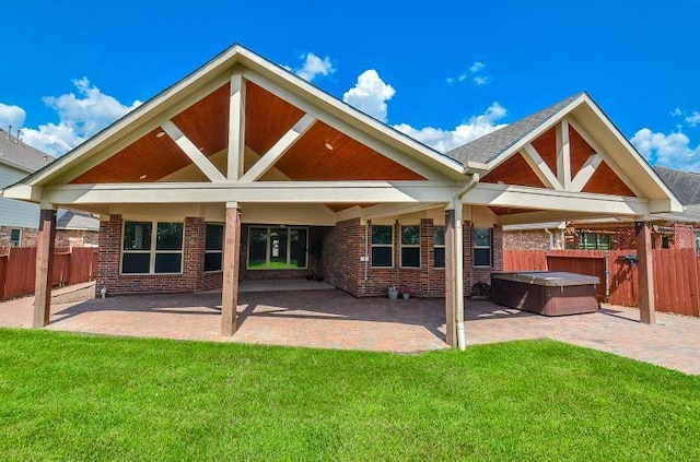 4327 Estes Ridge Ln, Katy, TX 77493 - back of house featuring a hot tub, a patio area, and brick siding
