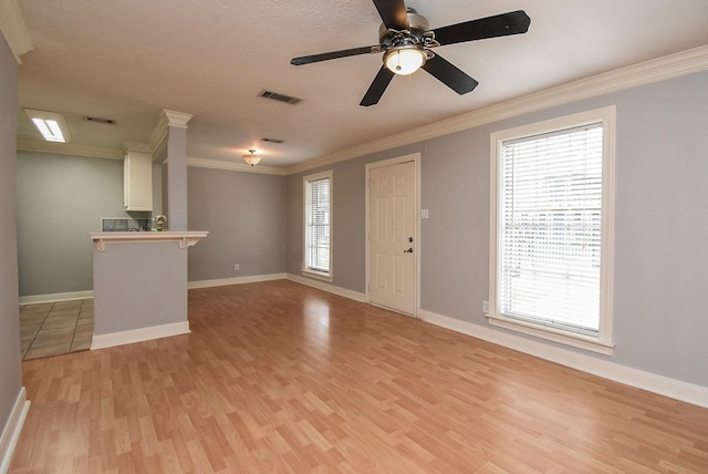 9005 Gaylord St Unit 19, Houston, TX 77024 - unfurnished living room with light wood-style floors, ornamental molding, and a ceiling fan