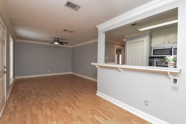 9005 Gaylord St Unit 19, Houston, TX 77024 - spare room featuring light wood-style flooring, a textured ceiling, ceiling fan, and ornamental molding