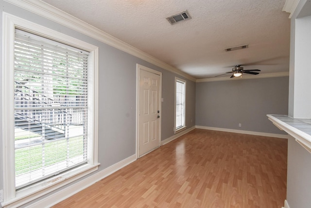 9005 Gaylord St Unit 19, Houston, TX 77024 - entrance foyer featuring plenty of natural light, light wood-style flooring, ceiling fan, crown molding, and a textured ceiling