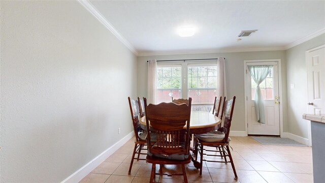1309 Bayswater Dr, Houston, TX 77047 - dining space with crown molding and light tile patterned floors