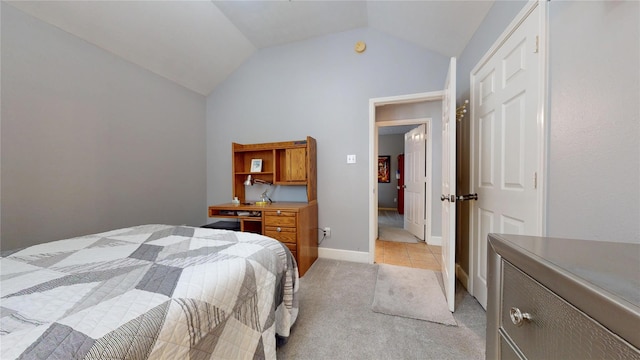 1309 Bayswater Dr, Houston, TX 77047 - bedroom featuring vaulted ceiling, light carpet, and light tile patterned floors