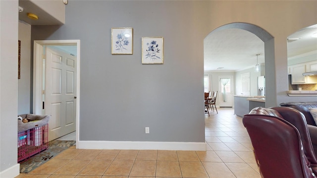 1309 Bayswater Dr, Houston, TX 77047 - hall with arched walkways, light tile patterned floors, and crown molding