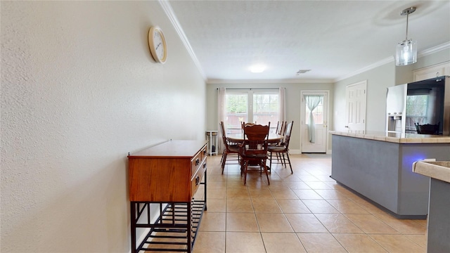 1309 Bayswater Dr, Houston, TX 77047 - dining room featuring crown molding, light tile patterned floors, and a textured wall