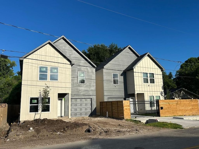 8923 De Priest St, Houston, TX 77088 - view of front of property featuring an attached garage and board and batten siding