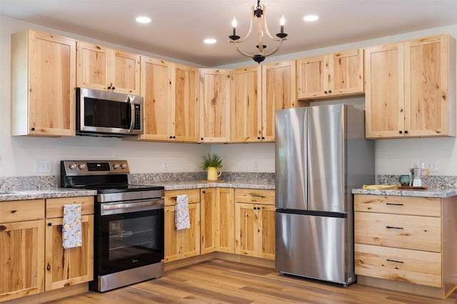 228 Cherry, Lexington, TX 78947 - kitchen featuring light brown cabinetry, stainless steel appliances, light wood finished floors, recessed lighting, and a chandelier