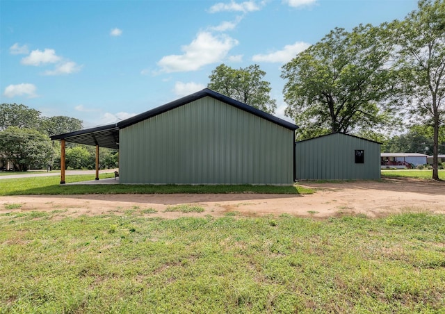 228 Cherry, Lexington, TX 78947 - view of pole building with a yard and a carport