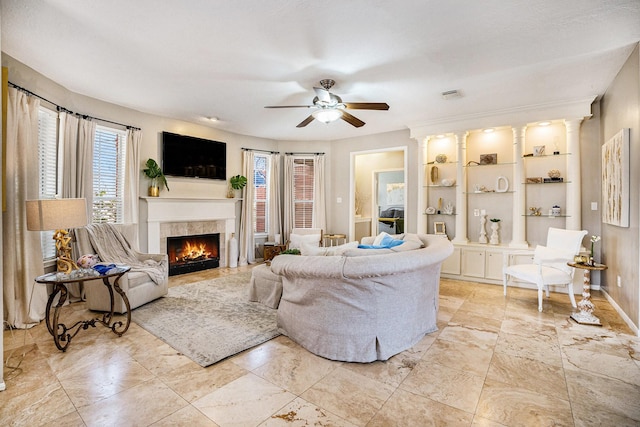 2602 Orleans Dr, Seabrook, TX 77586 - living area with ceiling fan, a tiled fireplace, and built in features
