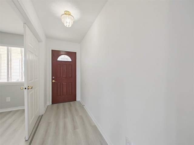 8818 Roos Rd, Houston, TX 77036 - doorway to outside featuring light wood-style flooring and baseboards