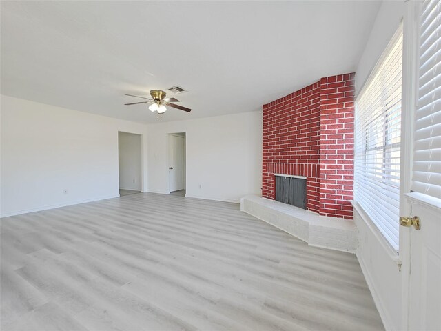 8818 Roos Rd, Houston, TX 77036 - unfurnished living room with ceiling fan, wood finished floors, and a brick fireplace