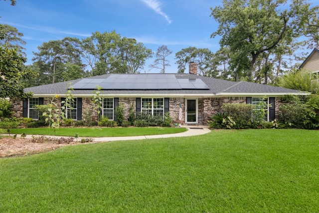 355 Cumberland Trl, Conroe, TX 77302 - ranch-style house featuring a front lawn, solar panels, a chimney, and roof with shingles