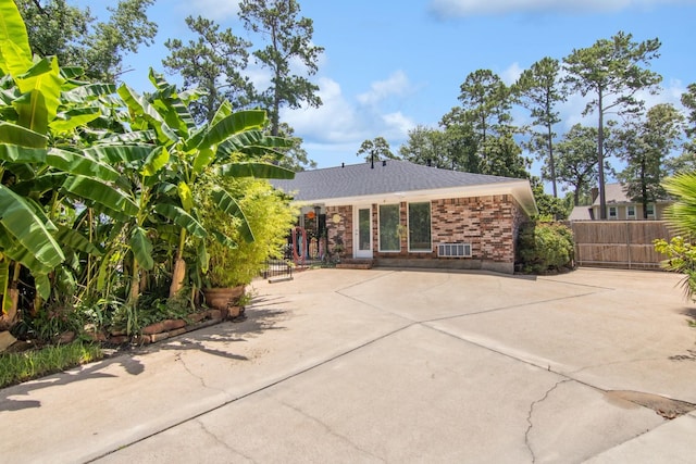 355 Cumberland Trl, Conroe, TX 77302 - rear view of property featuring brick siding and driveway