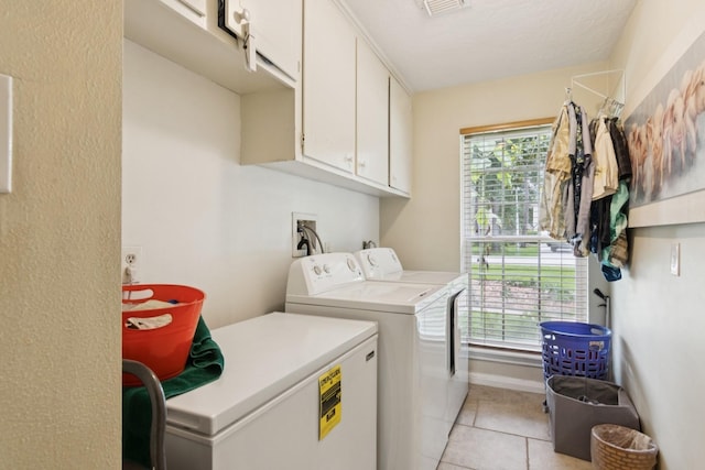 355 Cumberland Trl, Conroe, TX 77302 - laundry room featuring cabinet space, independent washer and dryer, and light tile patterned floors