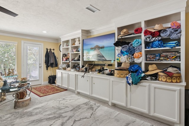 355 Cumberland Trl, Conroe, TX 77302 - mudroom with a textured ceiling, crown molding, and light carpet
