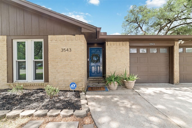 3543 Acorn Springs Ln, Spring, TX 77389 - doorway to property featuring brick siding, an attached garage, and concrete driveway