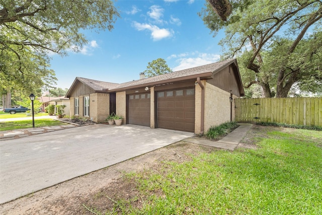 3543 Acorn Springs Ln, Spring, TX 77389 - view of side of property featuring brick siding, a garage, concrete driveway, a chimney, and a gate