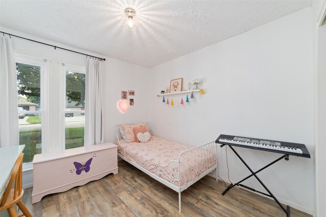 3543 Acorn Springs Ln, Spring, TX 77389 - bedroom featuring wood finished floors and a textured ceiling