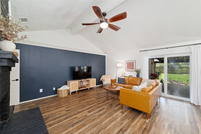 3543 Acorn Springs Ln, Spring, TX 77389 - living room with a ceiling fan, wood finished floors, beamed ceiling, a fireplace, and high vaulted ceiling