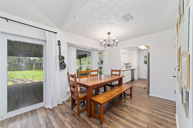 3543 Acorn Springs Ln, Spring, TX 77389 - dining area with a chandelier, dark wood finished floors, and a textured ceiling