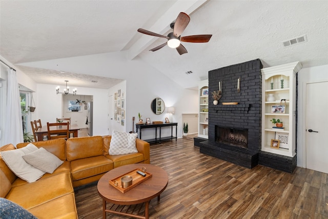 3543 Acorn Springs Ln, Spring, TX 77389 - living area featuring wood finished floors, a fireplace, a ceiling fan, and a chandelier