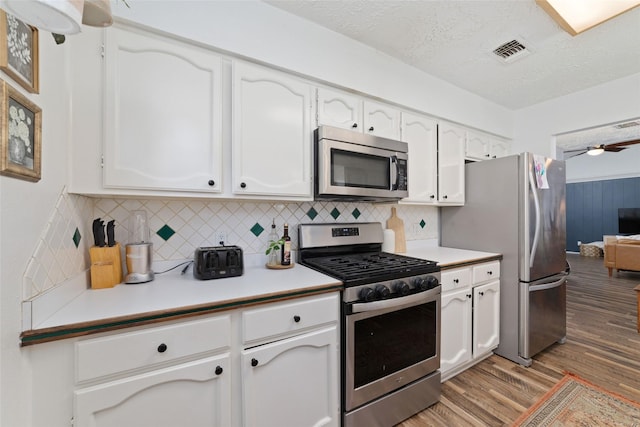 3543 Acorn Springs Ln, Spring, TX 77389 - kitchen with appliances with stainless steel finishes, light wood-type flooring, white cabinets, light countertops, and a textured ceiling