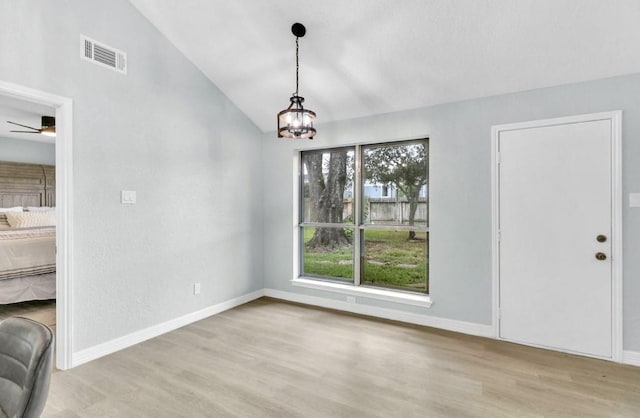 16307 N Mist Dr, Houston, TX 77073 - unfurnished dining area featuring wood finished floors, lofted ceiling, a chandelier, and a ceiling fan
