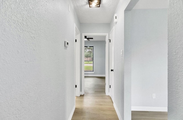 16307 N Mist Dr, Houston, TX 77073 - corridor featuring a textured wall, wood finished floors, and a textured ceiling