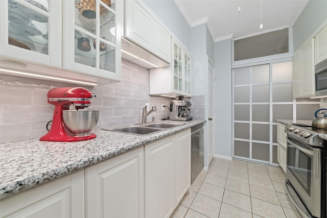 2400 N Braeswood Blvd Unit 108, Houston, TX 77030 - kitchen featuring appliances with stainless steel finishes, crown molding, backsplash, and white cabinetry