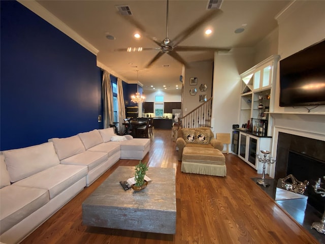 5809 Larkin St, Houston, TX 77007 - living area featuring ceiling fan, a fireplace with flush hearth, stairway, wood finished floors, and a chandelier