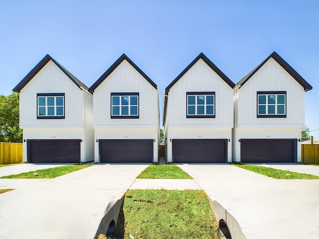6417 Madrid St, Houston, TX 77021 - view of front facade featuring a garage, driveway, and board and batten siding