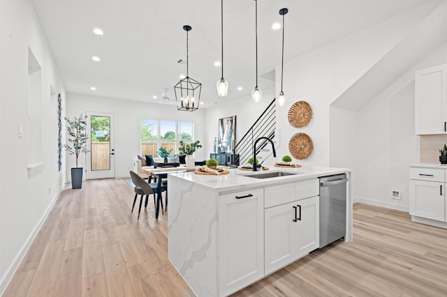 6417 Madrid St, Houston, TX 77021 - kitchen with dishwasher, light wood-style floors, recessed lighting, a chandelier, and light stone countertops