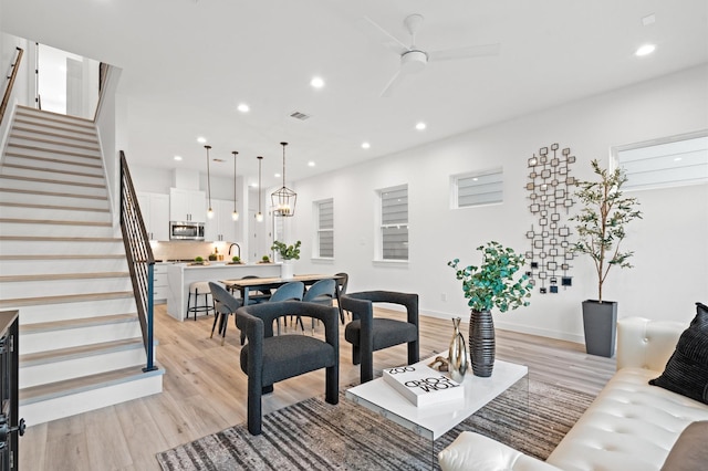 6417 Madrid St, Houston, TX 77021 - living room with light wood-style flooring, stairway, recessed lighting, and ceiling fan