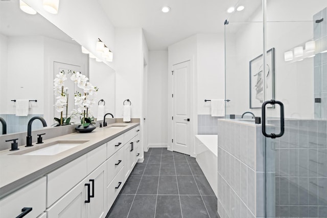 6417 Madrid St, Houston, TX 77021 - bathroom with double vanity, a garden tub, tile patterned flooring, a stall shower, and recessed lighting