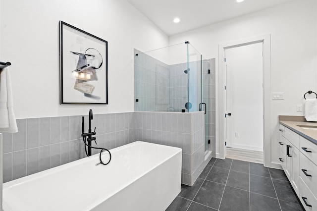 6417 Madrid St, Houston, TX 77021 - bathroom featuring a soaking tub, a stall shower, vanity, tile patterned floors, and recessed lighting