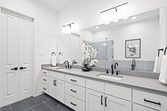 6417 Madrid St, Houston, TX 77021 - bathroom with double vanity, tile patterned floors, tiled shower, and recessed lighting