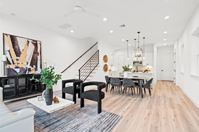 6417 Madrid St, Houston, TX 77021 - living area with light wood-type flooring, recessed lighting, stairs, and a ceiling fan