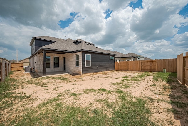 27206 Clear Breeze Dr, Katy, TX 77493 - rear view of property featuring a patio, roof with shingles, a fenced backyard, and brick siding